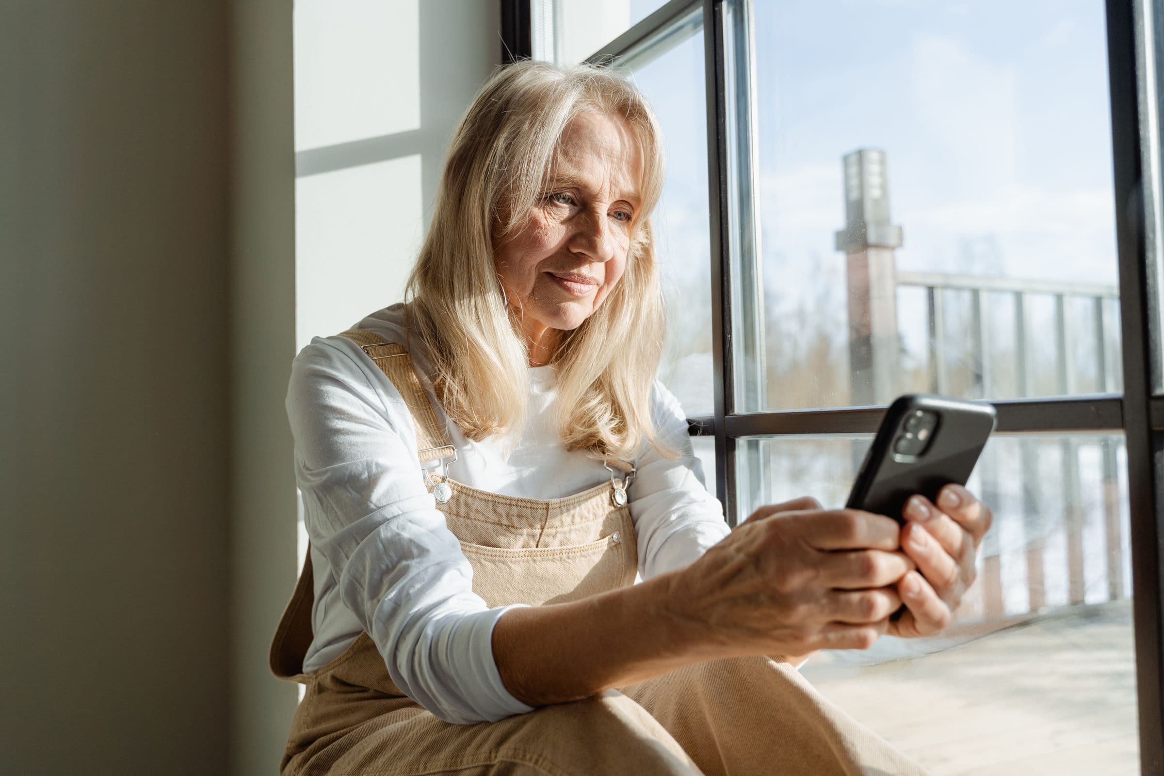 A person answering a survey on their phone in warm natural light.